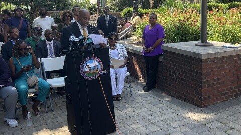 City Council President Trippi Congo addresses a crowd of residents and reporters following the shooting and death of Kadir Skinner.