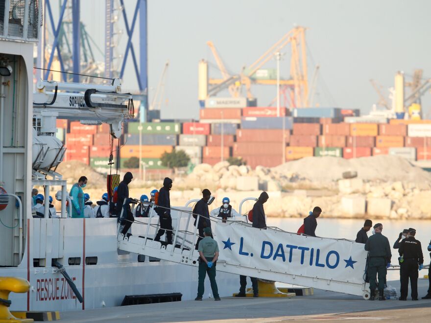 Migrants disembark from Italian coast guard boat the Dattilo at the port of Valencia on Sunday.