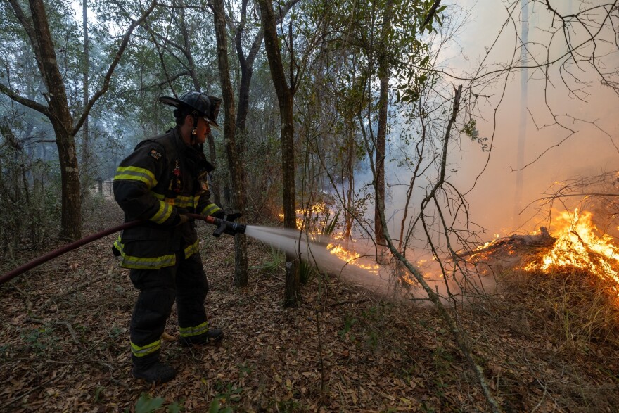 Crews with Marion County Fire Rescue work to contain a large fire affecting about 40 acres in the Oak Circle Drive area of Silver Springs Shores, Ocala on Jan. 31. No injuries were reported from the fire.