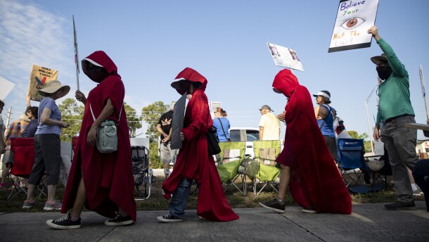 People dressed as characters from author Margaret Atwood's "The Handmaiden's Tale," were among the thousands who came to U.S. 41 and Daniels parkway in Fort Myers Saturday for the third No Kinmgs protest rally. Similar events were held in various Southwest Florida sites, other parts of the state and across the United States and the world.