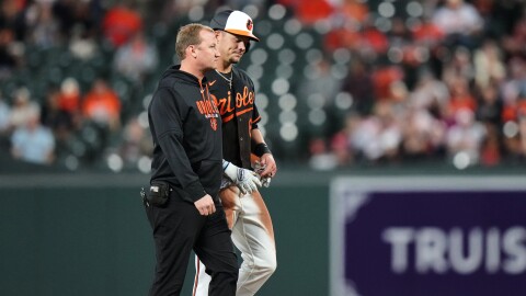Baltimore Orioles' Ryan Mountcastle, right, leaves the field after an injury on a double during the second inning of a baseball game against the San Francisco Giants, Saturday, April 11, 2026, in Baltimore. (AP Photo/Stephanie Scarbrough)