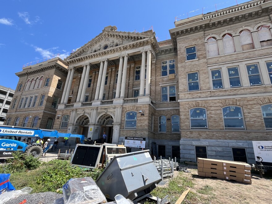 Supplies and equipment await installation on the front lawn of the school.
