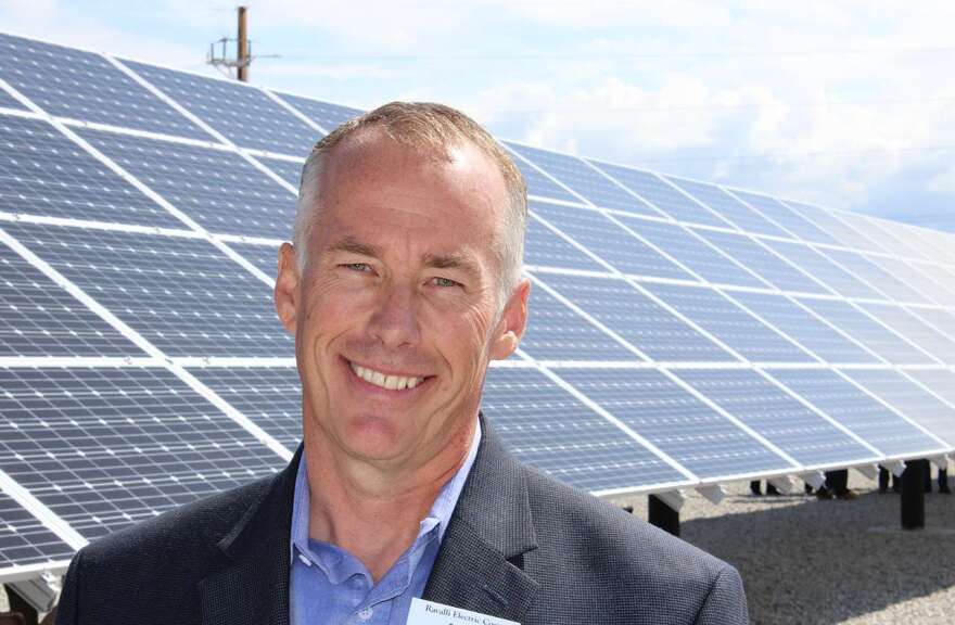 Mark Grotbo, general manager of Ravalli Electric Co-op stands in front of the solar panels that now line the side of Highway 93 near Victor.