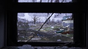 Debris is visible through the window of a damaged home following severe storms Friday, March 15, 2024, in Lakeview, Ohio.