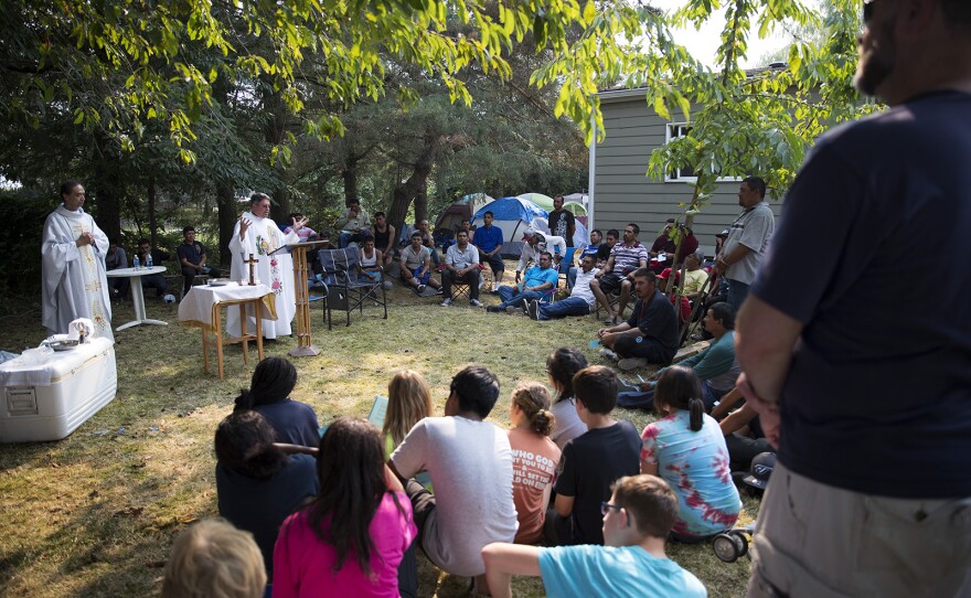 A mass is held in honor of Honesto Silva Ibarra, an H-2A farm worker who died after working at Sarbanand Farms. The mass was held at a private home where workers who were fired camped out.