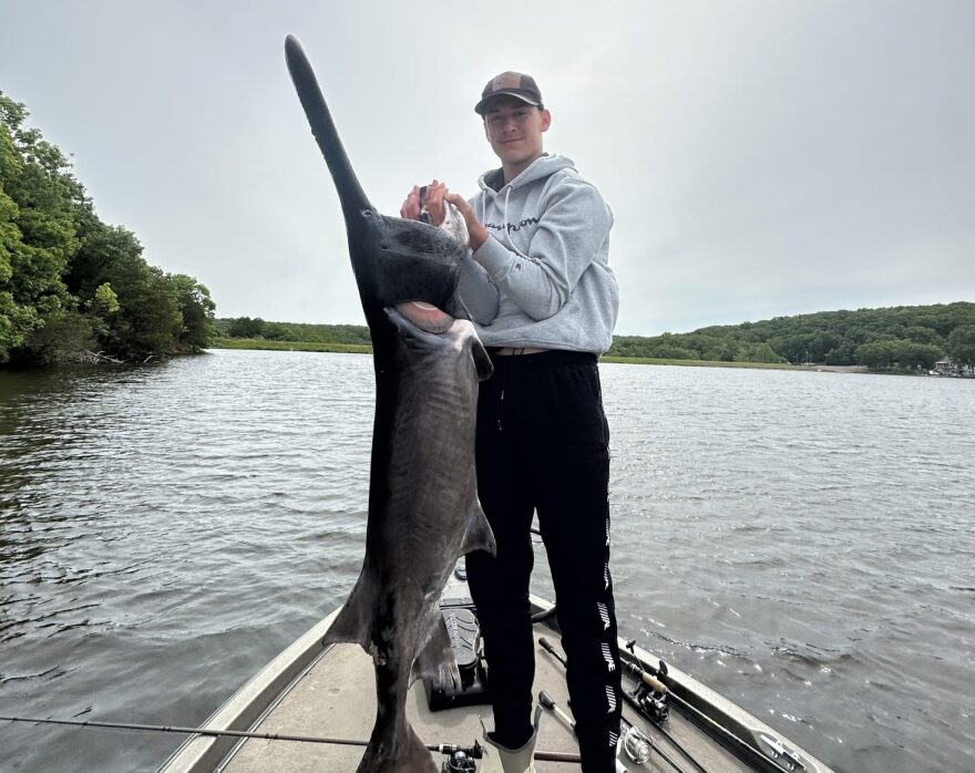 Luke Karg stands with a paddlefish he caught in Owensville