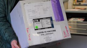 Person holding white cardboard box