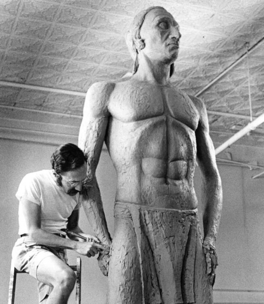 The sculptor, caught working in the studio, bringing Chief Little Turtle to life.