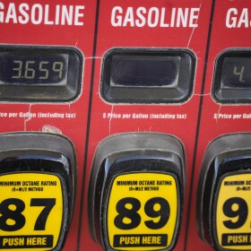 FILE - The prices of the various grades of gasoline available are displayed electronically on a pump at a filling station.