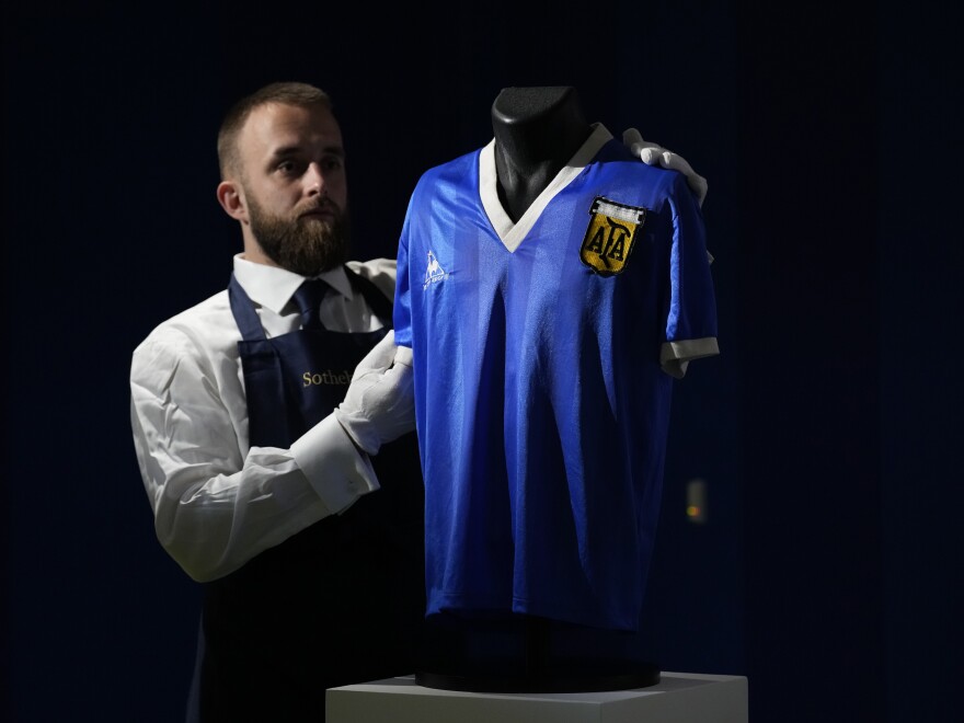 The Argentina football shirt worn by Diego Maradona in the 1986 Mexico World Cup quarterfinal soccer match between Argentina and England, is displayed for photographs at Sotheby's auction house, in London, on April 20. The shirt worn by Maradona when he scored the controversial "Hand of God" goal has sold for $9.3 million.