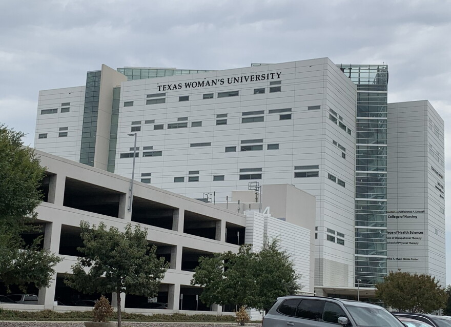 multi story white building and garage, that says Texas Woman's University