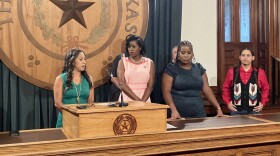 Three Democrats on the Texas State Board of Education stand behind a podium at the Texas Capitol for a news conference. 