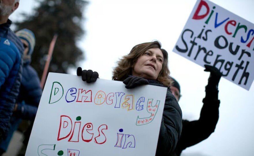 Whitney Selover, 63, of Redmond, Ore., says she came to protest at Peace Corner in Bend to "try to make a difference in this terrifying world, right now, with Trump in control."