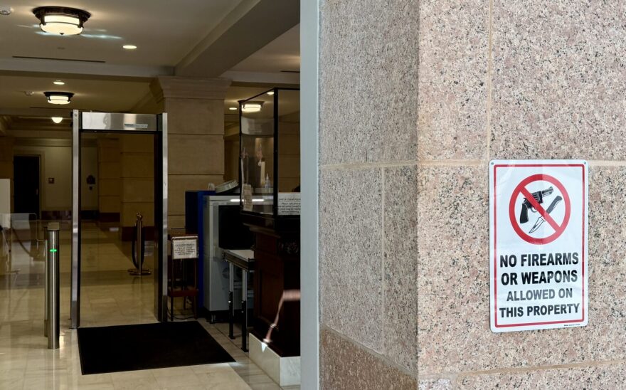 A sign outside of a security checkpoint at the Oklahoma Capitol reads “No firearms or weapons allowed on this property.”