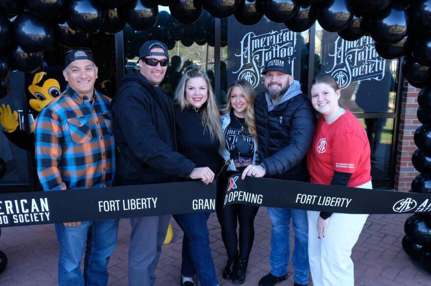 American Tattoo Society officials pose together during ribbon cutting ceremony.