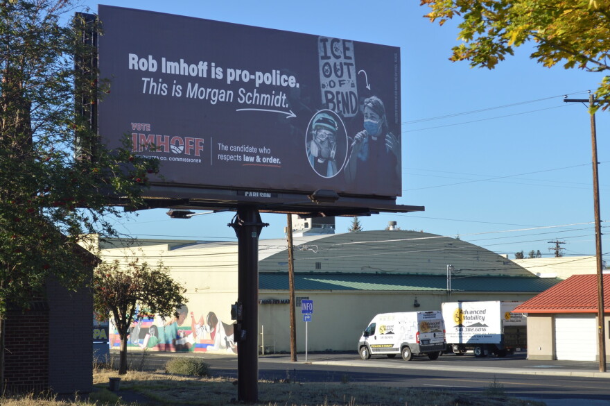 An attack ad billboard on Thursday, Oct. 8, 2026 along a busy street in Bend. Ore., has caused a stir in the race for Deschutes County Commissioner with candidate Rob Imhoff using images of opponent Morgan Schmidt at a 2020 protest against immigration arrests in the city.