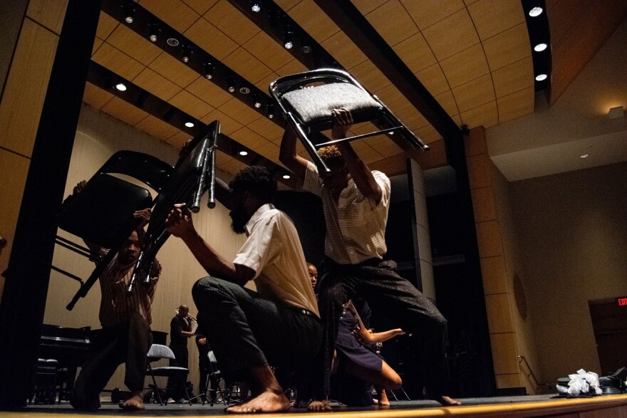 Dancers perform as part of Nine Lives Project. The nine chairs represent each victim of the 2015 Charleston church shooting.