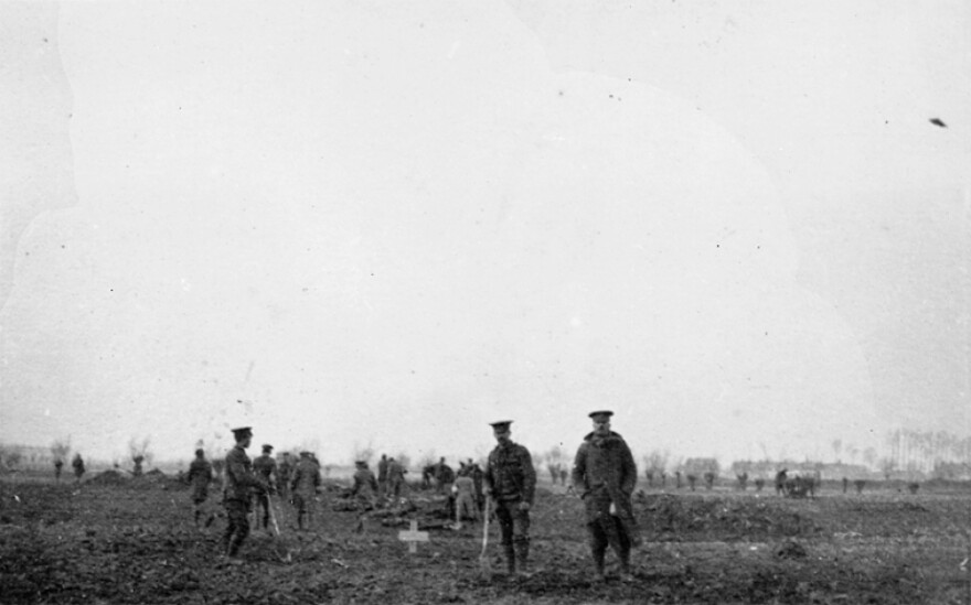 The 1914 Christmas truce was an opportunity for both sides to bury their dead. Alan Wakefield of the Imperial War Museum, describes the photo: "Four British soldiers in the foreground (are) beside a grave, a recently dug grave. And a mixed group of German and British in the background, actually digging fresh graves for other casualties."