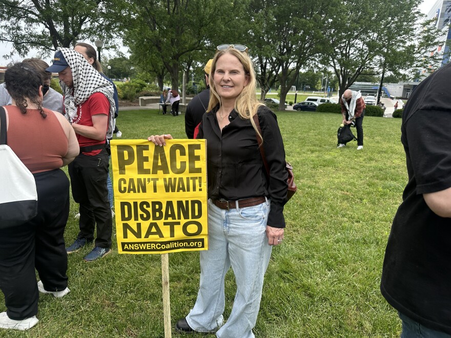 image, woman standing next to yellow sign.