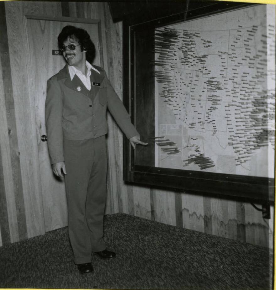 John Ahlers points to the precipitation map at the WSU Waterworld pavilion.