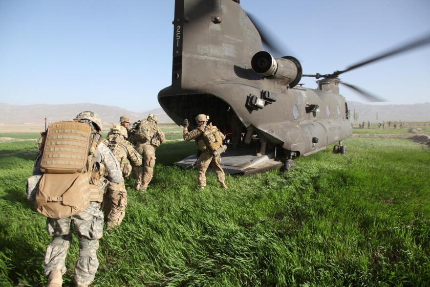 U.S. Army soldiers with the 1st Battalion, 6th Field Artillery Regiment, Focused Targeting Force, 3rd Brigade, 1st Infantry Division, prepare to board a CH-47 Chinook helicopter in Gardez, Paktiya province, Afghanistan, on April 27, 2011.