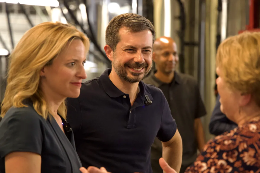 Jocelyn Benson and Pete Buttigieg talk to a voter at Right Brain Brewery in Traverse City on July 6, 2026. Buttigieg endorsed Benson in her bid for governor. (Photo: Simon D. Schuster/Bridge Michigan)