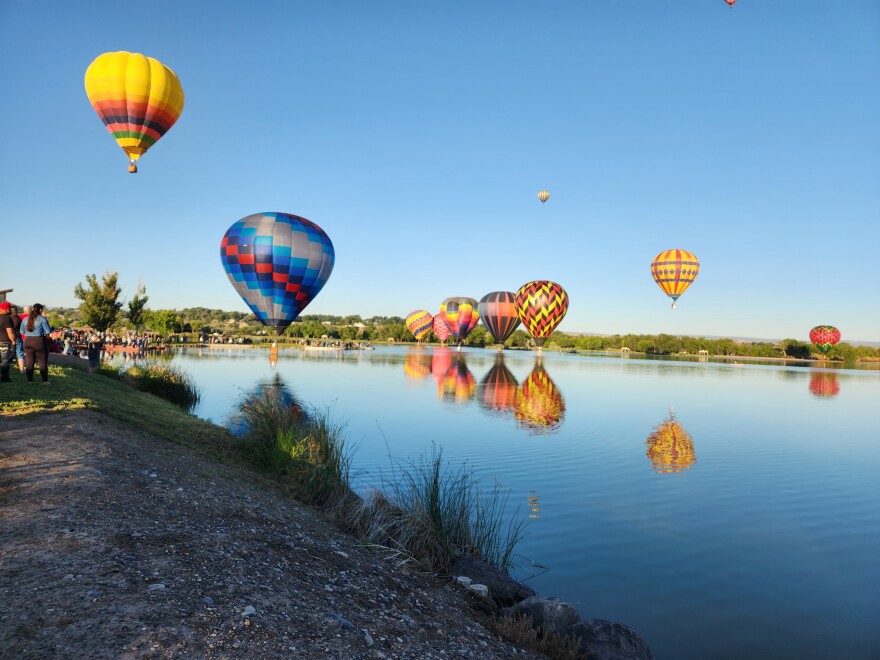 Balloons 'splash n' dash' in the calm waters of Confluence Lake in Delta, Colorado during the 4th of July Western Sky Balloon Festival
