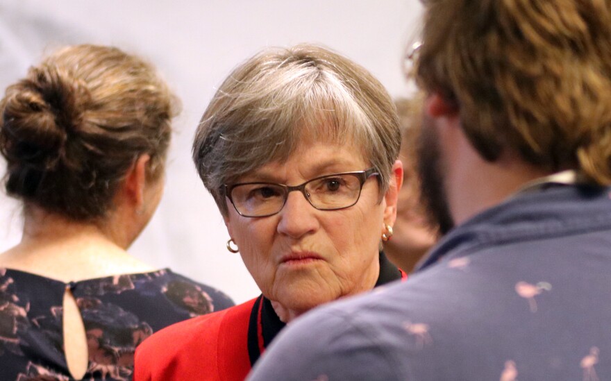 Kansas Governor Laura Kelly speaks to a person attending a press conference on Tuesday, May 14. Kelly is vetoing state lawmakers' latest attempt to pass tax cuts and will call them back to Topeka for a special session.