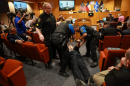 Lon Burnam, former Texas House representative, is arrested during a Tarrant County Commissioners Court meeting Aug. 4, 2026, in Fort Worth.