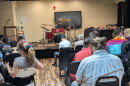 The expectant crowd waits as the competitors get ready to demonstrate their skills behind a massive drum set