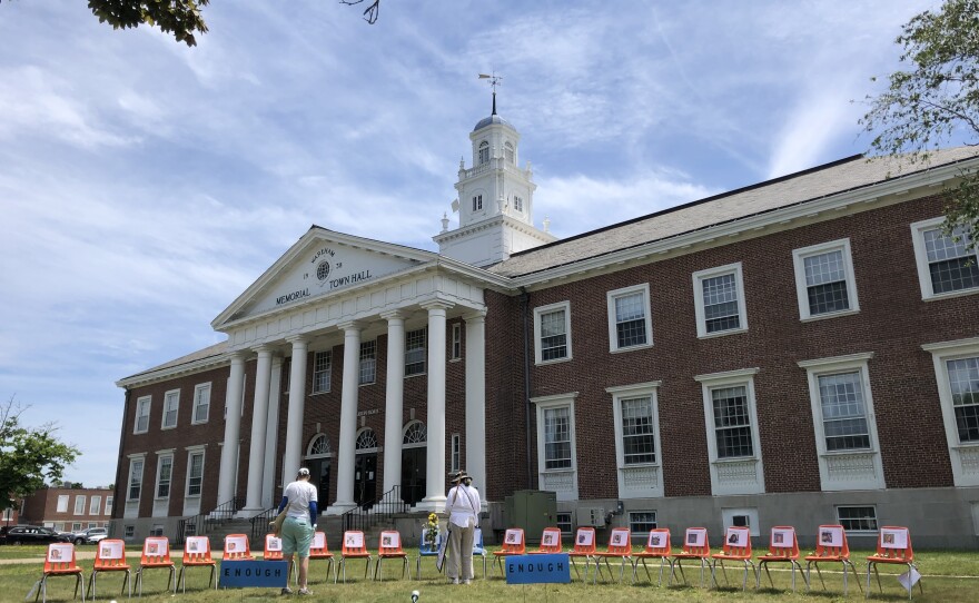 Chairs sit empty on the Wareham Town Hall lawn to honor each child and teacher shot and killed in a Texas classroom.