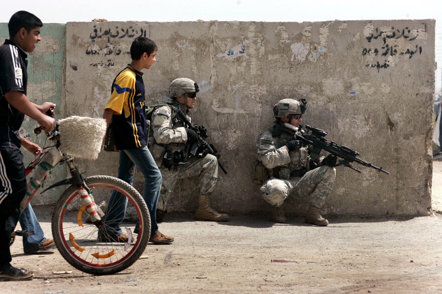 U.S. Army soldiers take up a position during a patrol in Baghdad in 2007. The U.S. has been waging war nonstop for 15 years since the Sept. 11 attacks. Despite the protracted conflicts and disappointing results, U.S. involvement in multiple wars appears set to continue for years to come.