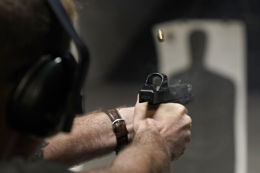 Ettore Russo fires his pistol at an indoor shooting range during a qualification course to renew his Carry Concealed handgun permit at the Placer Sporting Club in Roseville, Calif., on Friday, July 1, 2022. (AP Photo/Rich Pedroncelli)