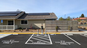 A building and a parking lot with EV charging station spaces.