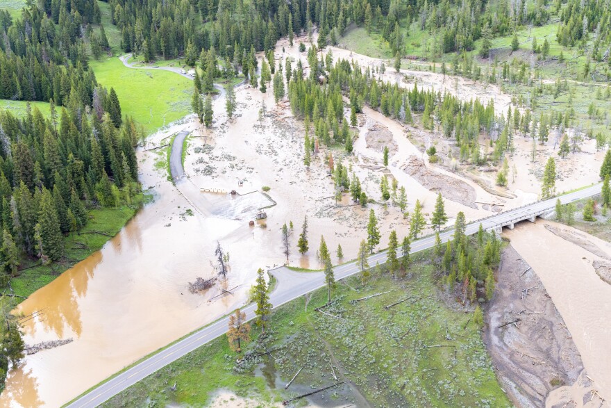 An areal view of flooding in Pebble Creek Campground of Yellowstone National Park. Muddy water covers a road and green space.