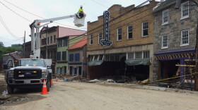 Utility workers check the power lines on Main Street after Sunday's floodwaters that raged down the downtown district in Ellicott City, Md., Tuesday, May 29, 2018. (Courtney Columbus/AP)