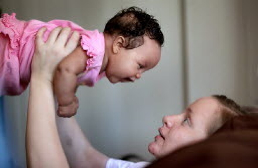 Nicole Smith holds her 3-month-old daughter, Annie, at their home in Lakewood.  - Marvin Fong, The Plain Dealer