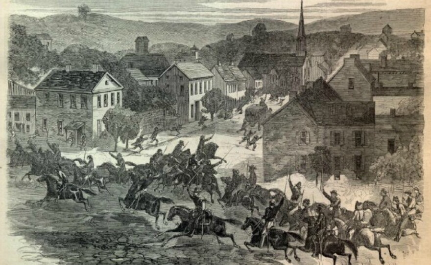 A 19th-century engraving depicting Confederate cavalry troops under General John Hunt Morgan riding aggressively on horses through the streets of Washington, Ohio, during an 1863 Civil War raid.