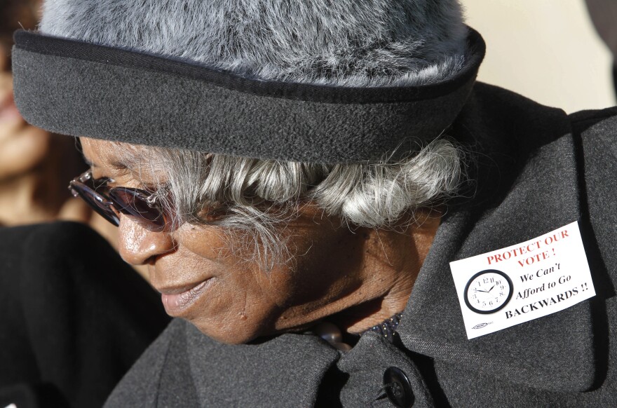 This Tuesday Jan. 31, 2012 file photo shows State Sen. Yvonne Miller, D-Norfolk, as she listens to speeches during a rally at the Capitol in Richmond, Va. Miller, the first African American woman elected to Virginia's state legislature, died in 2012. She was 77.