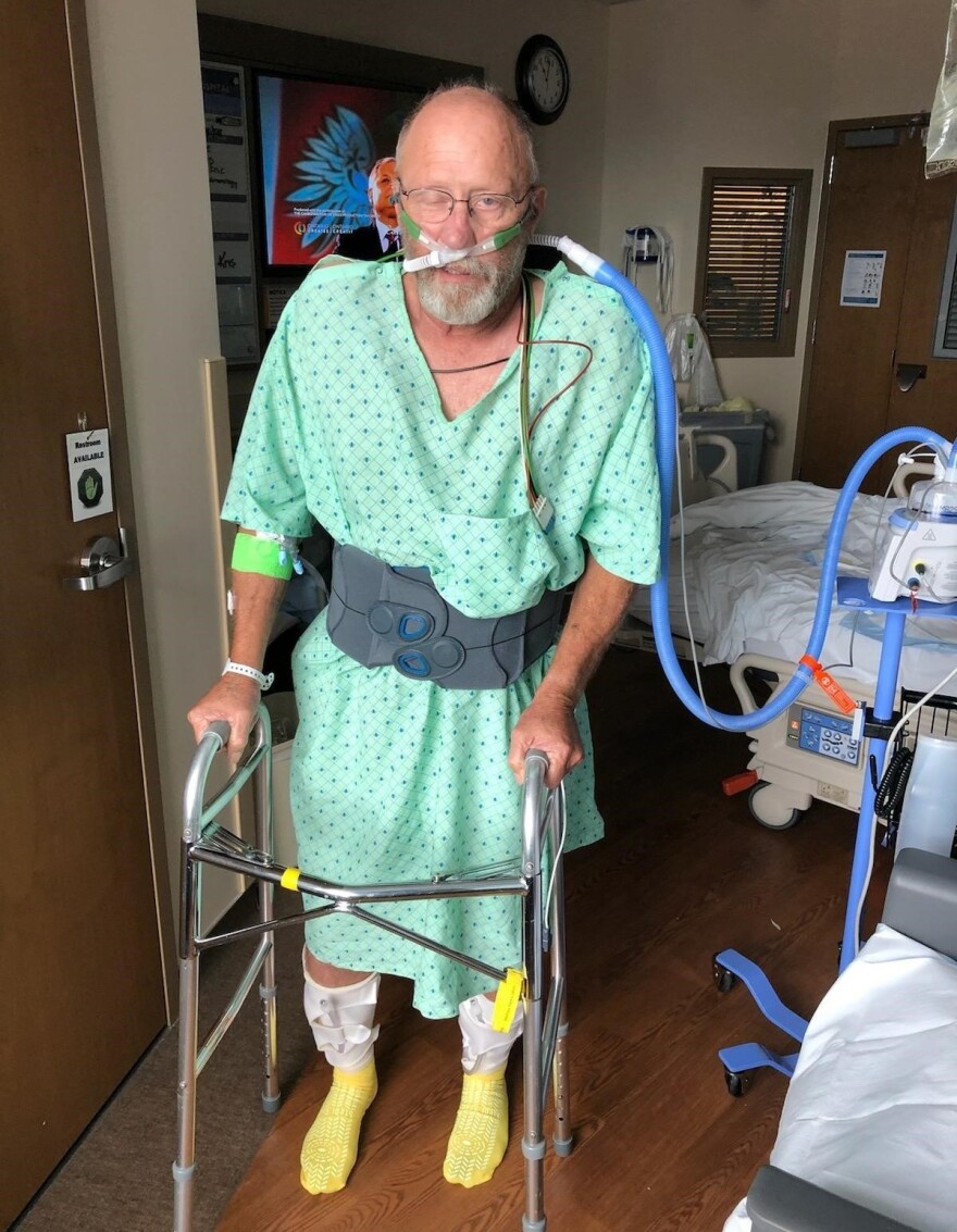 Chad Larsen, Wootton's father, stands for the first time in over a month. Larsen contracted COVID-19 after he was initially hospitalized for something else.