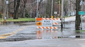 A road closed sign is seen on a flooded street in Shiocton, Wis. on April 15, 2026.