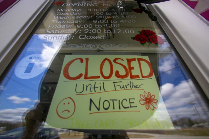 A sign announces a coronavirus closure at a flower shop in Jay, Maine, Thursday, April 16, 2020.