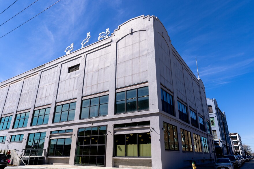 Neon rabbit signs adorn the top of the building housing The Rabbit hOle.