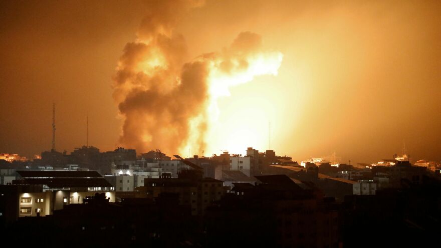 An Israeli airstrike on buildings in Gaza City turns the sky bright with fire and smoke, after a day in which a surprise large-scale attack by Palestinian militants left at least 250 Israelis dead. More than 230 Palestinians have been killed.