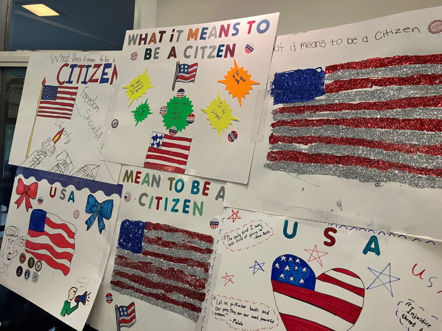 Some of the student artwork from local Catholic schools, on what citizenship means, displayed in the Centennial Hall lobby.