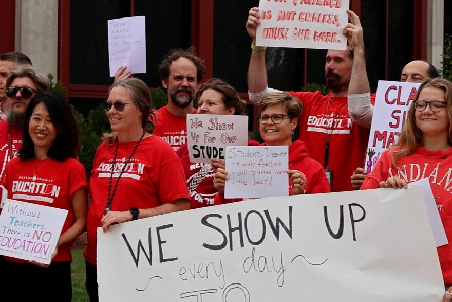 Teachers stand outside Bloomington High School North wearing red to show solidarity for teachers during contract negotiations.