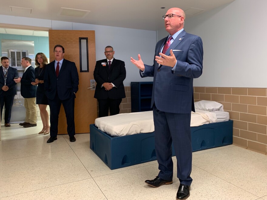 Tim Bray with the Texas Health and Human Services Commission explains the features of a patient room in the new veterans unit at Terrell State Hospital.