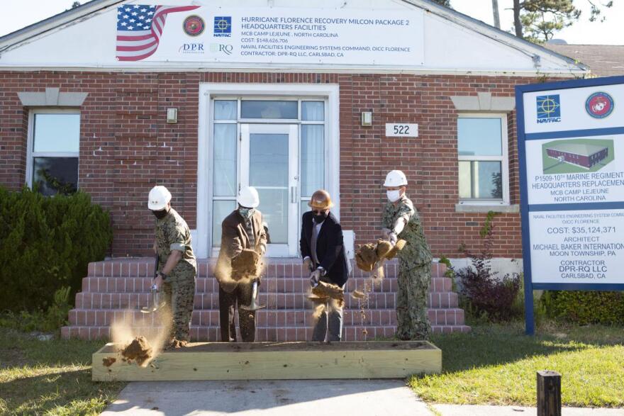 The former headquarters of the 10th Marine Regiment at Camp Lejeune served as a backdrop for the ceremonial groundbreaking. It is scheduled to be torn down and replaced by a new building on higher ground.