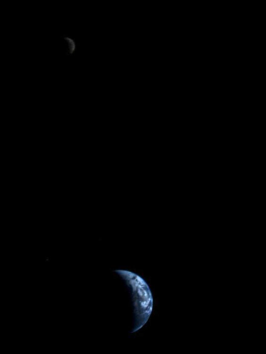 This image of the Earth and moon (upper left) in a single frame, the first of its kind ever taken by a spacecraft, was recorded by Voyager 1 on Sept. 18, 1977.