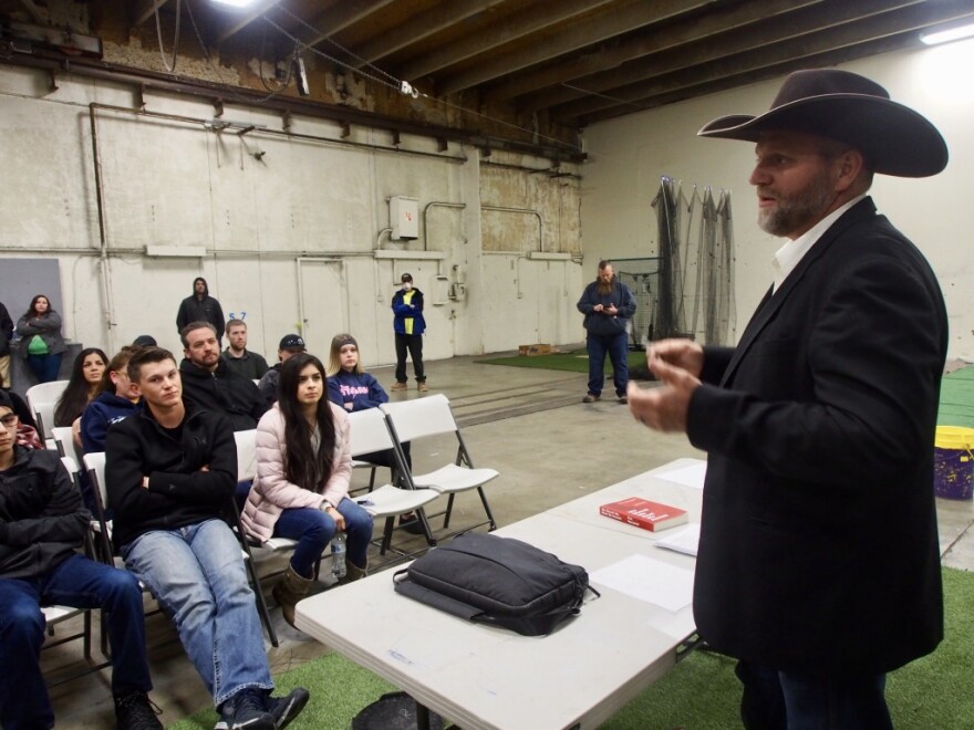 Ammon Bundy, right, rails against Idaho’s stay-at-home order to a crowd in Emmett, Idaho, on March 26, 2020.